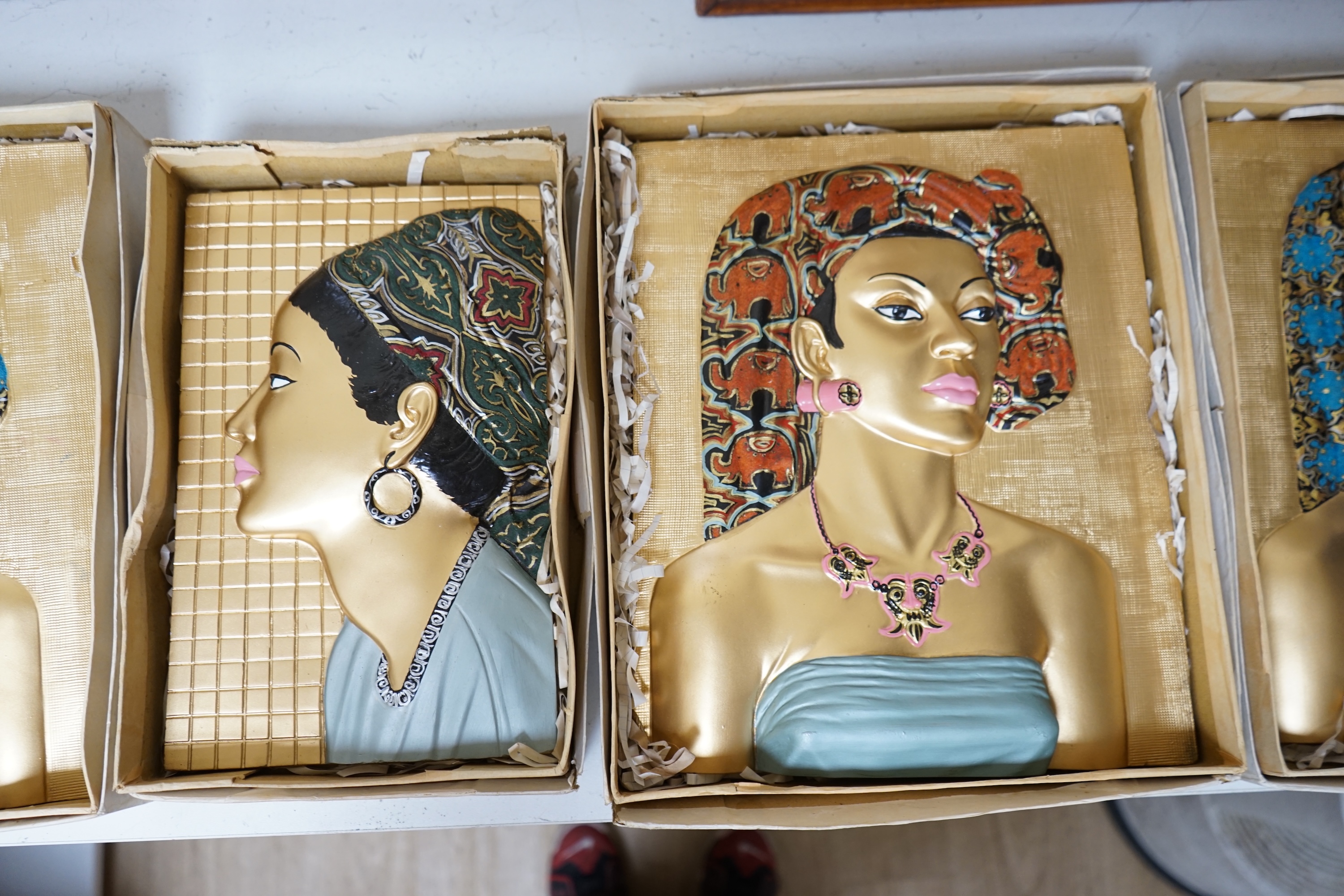 Five moulded and hand painted plaster plaques, busts of women, in original boxes, 35cm high. Condition - good